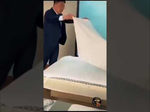 Hotel manager teaches the staff the skill of bed making