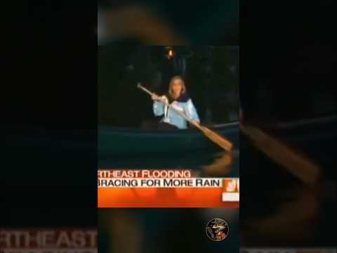 Reporter canoeing in about 6 inches of flood water while 2 guys easily pass through 😂